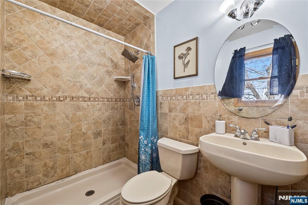 391 Taylor, Unit 2 Hackensack, NJ 07601 - Photo 14 of 15 a bathroom with a sink toilet and shower