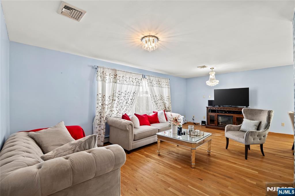 391 Taylor, Unit 2 Hackensack, NJ 07601 - Photo 3 of 15 a living room with furniture and a flat screen tv
