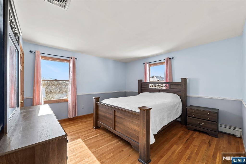 391 Taylor, Unit 2 Hackensack, NJ 07601 - Photo 9 of 15 a bed room with a bed and a window