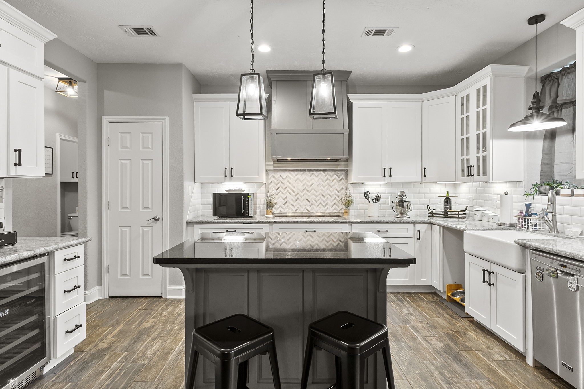 6938 Old Honey Island Road Kountze, TX 77625 - Photo 11 of 34 a kitchen with stainless steel appliances granite countertop a table chairs sink refrigerator and cabinets