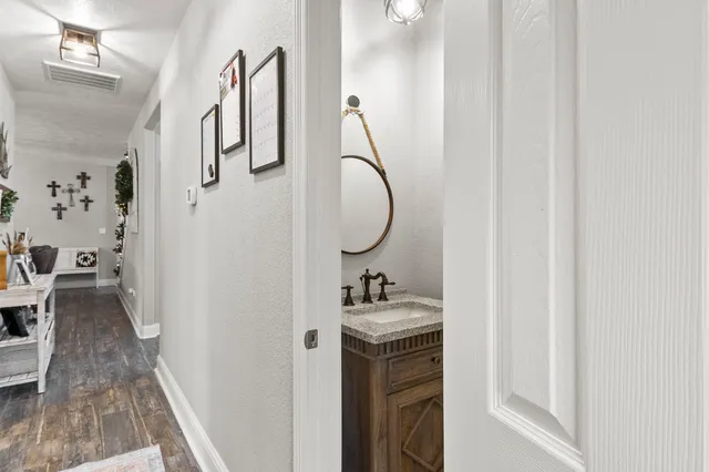 a bathroom with a sink a toilet and a mirror