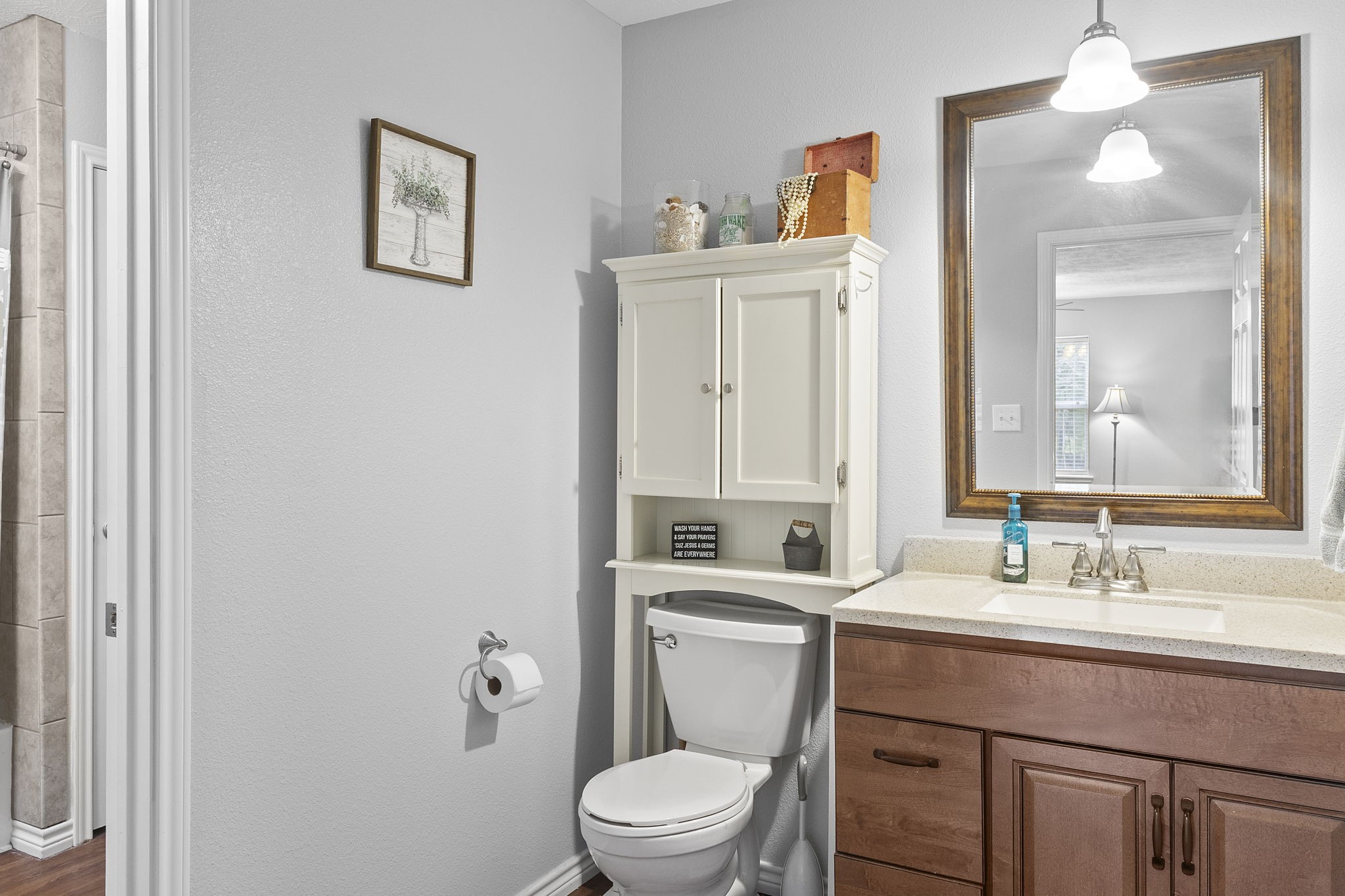 6938 Old Honey Island Road Kountze, TX 77625 - Photo 20 of 34 a bathroom with a toilet a sink and mirror