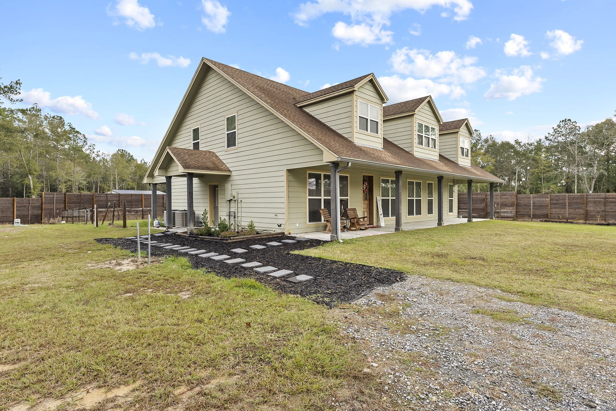 6938 Old Honey Island Road Kountze, TX 77625 - Photo 2 of 34 a front view of a house with swimming pool