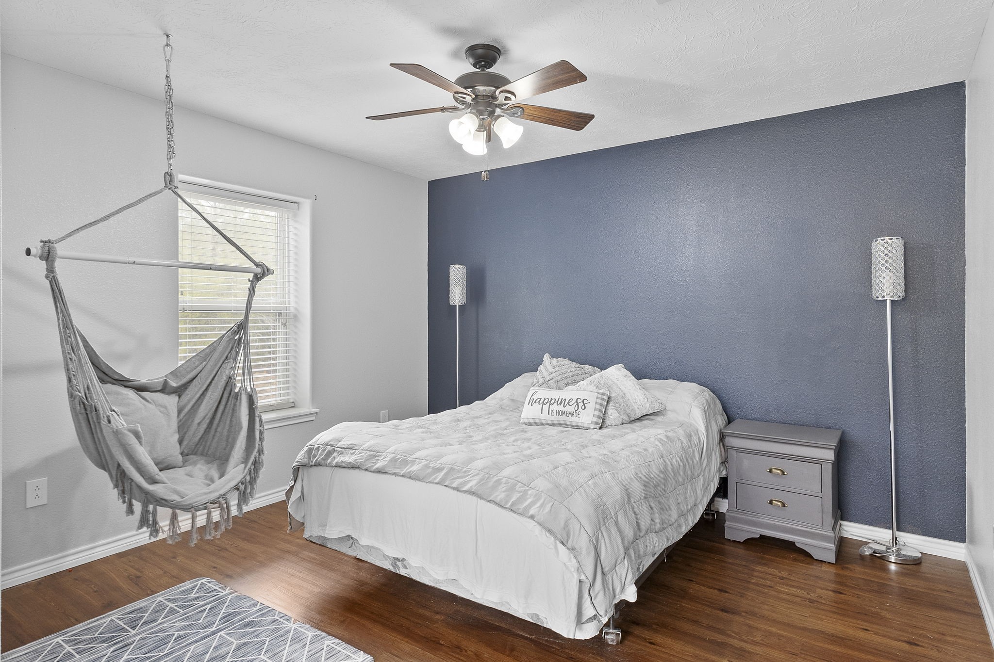 6938 Old Honey Island Road Kountze, TX 77625 - Photo 24 of 34 a bedroom with a bed and wooden floor