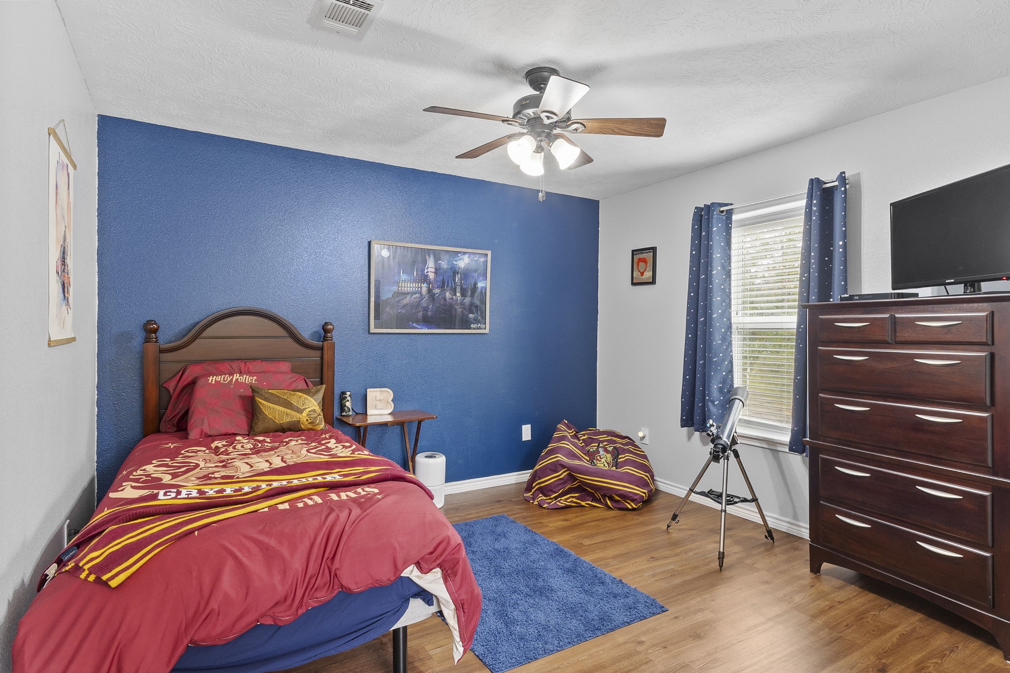 6938 Old Honey Island Road Kountze, TX 77625 - Photo 26 of 34 a bedroom with a bed and a flat screen tv