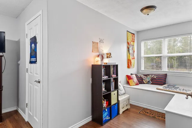a view of a large building next to a yard with palm trees