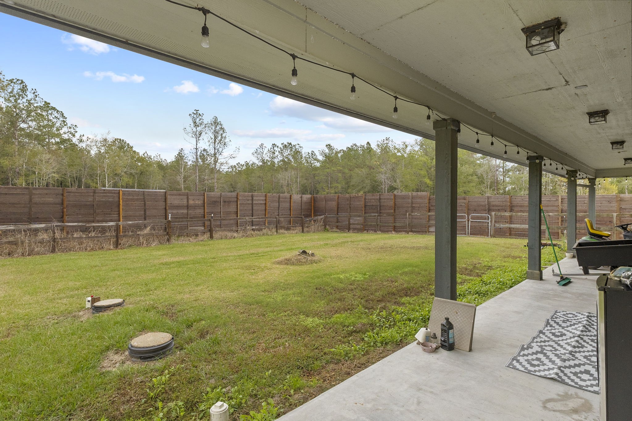 6938 Old Honey Island Road Kountze, TX 77625 - Photo 32 of 34 a view of a porch with furniture and garden