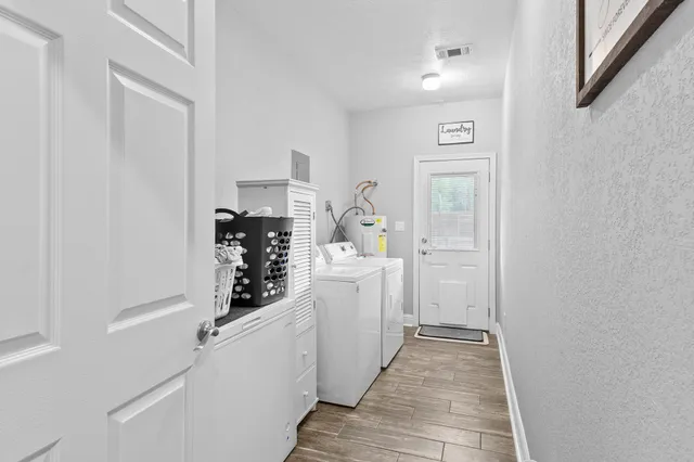 a view of a hallway with washer and dryer