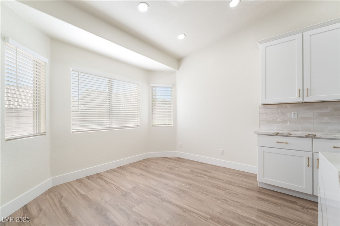 9205 Desert Village Avenue Las Vegas, NV 89147 - Photo 13 of 44 Unfurnished dining area featuring light wood-style floors and recessed lighting
