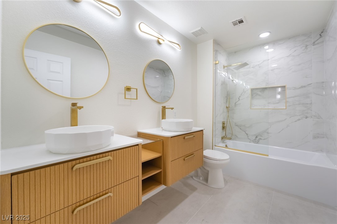 9205 Desert Village Avenue Las Vegas, NV 89147 - Photo 1 of 44 Bathroom with two vanities, recessed lighting, a combined bath / shower with marble appearance, and light tile patterned flooring
