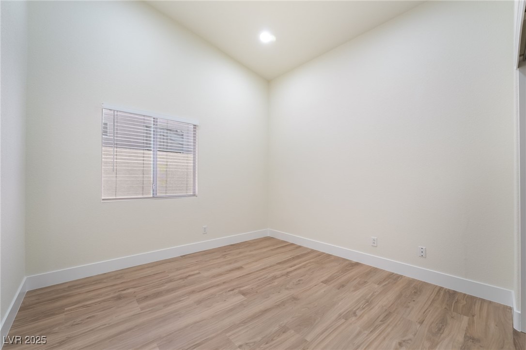 9205 Desert Village Avenue Las Vegas, NV 89147 - Photo 29 of 44 Unfurnished room with light wood-type flooring, vaulted ceiling, and recessed lighting