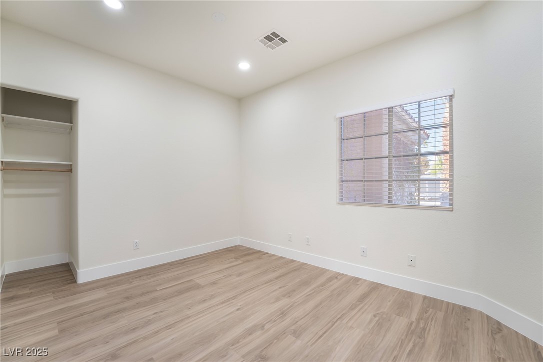 9205 Desert Village Avenue Las Vegas, NV 89147 - Photo 32 of 44 Unfurnished bedroom featuring light wood-type flooring, a closet, and recessed lighting