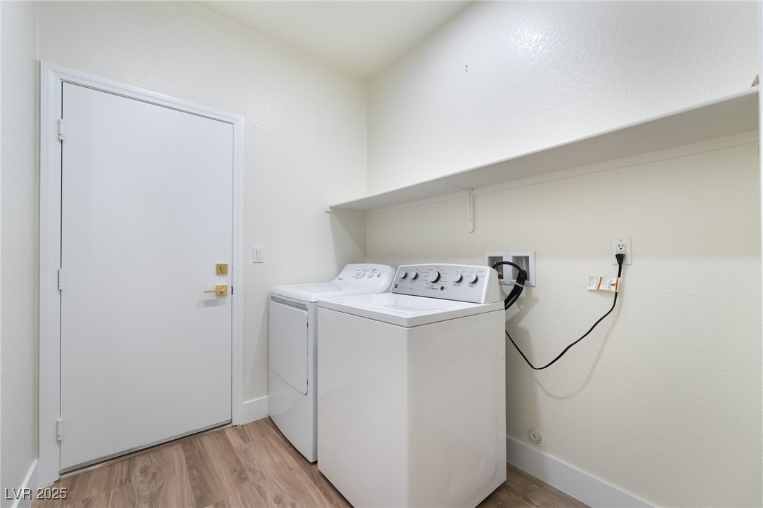 9205 Desert Village Avenue Las Vegas, NV 89147 - Photo 35 of 44 Laundry area with light wood-style floors and separate washer and dryer