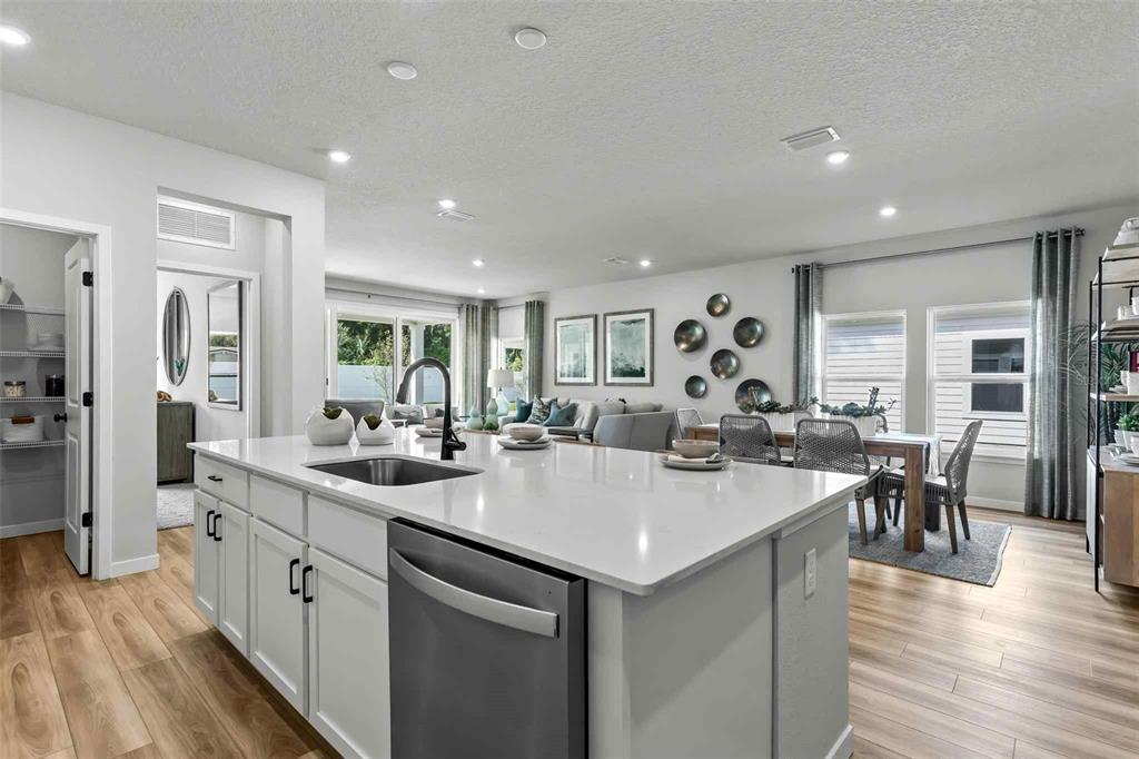 89 Pegasus Road Flagler Beach, FL 32136 - Photo 15 of 35 a large kitchen with kitchen island a sink table and chairs