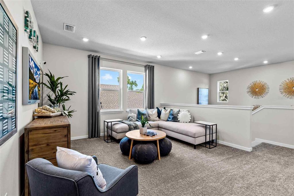 89 Pegasus Road Flagler Beach, FL 32136 - Photo 24 of 35 a living room with furniture and a potted plant