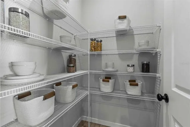 a view of a chair and table in back yard of the house