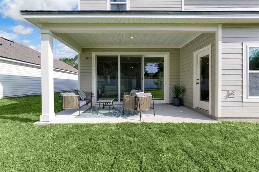 89 Pegasus Road Flagler Beach, FL 32136 - Photo 26 of 35 a view of a chair and table in back yard of the house