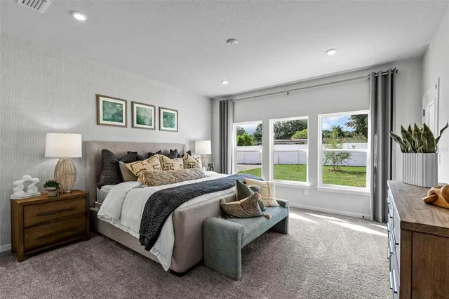 a bedroom with a large bed and a dresser