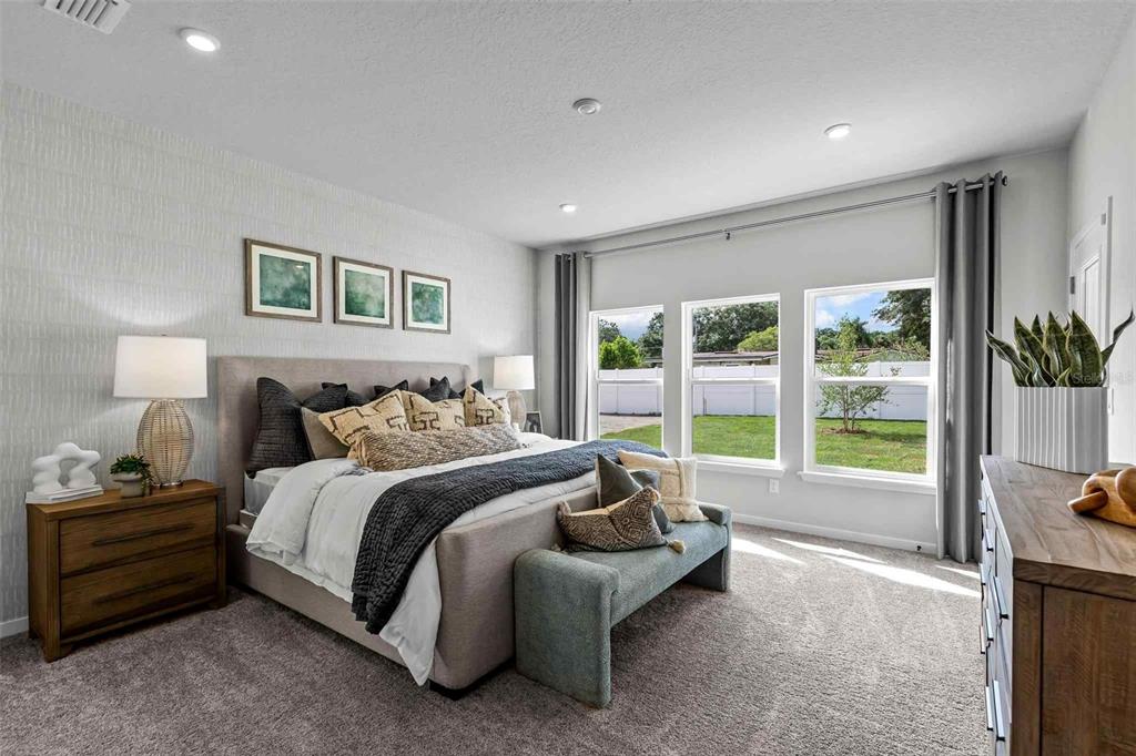 89 Pegasus Road Flagler Beach, FL 32136 - Photo 27 of 35 a spacious bedroom with a bed and a couch