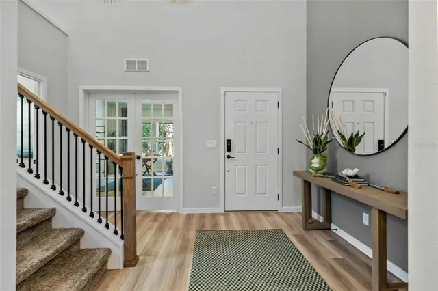 a view of an entryway with wooden floor