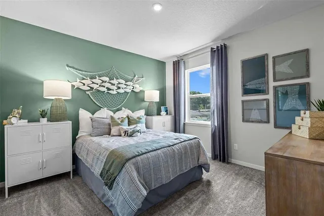 a bedroom with a large bed and a chandelier