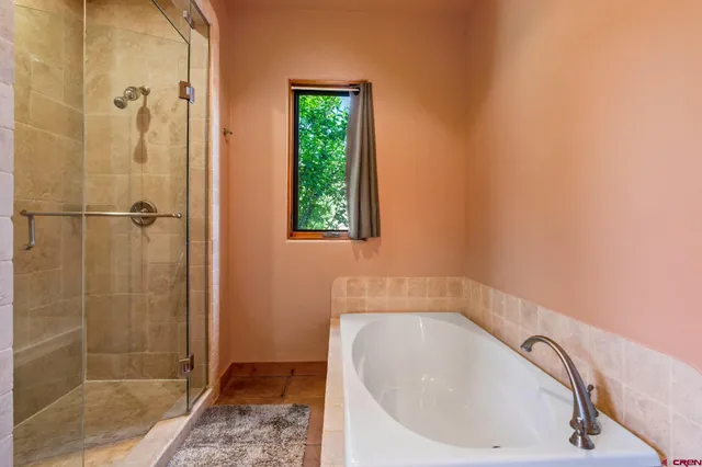 a bathroom with a bathtub and shower