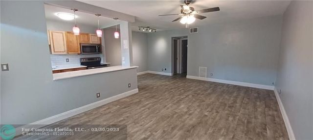 a view of a kitchen with a sink and cabinet area