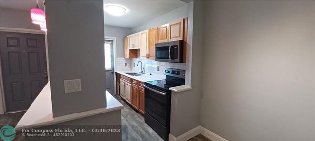 a kitchen with stainless steel appliances granite countertop a refrigerator and a stove