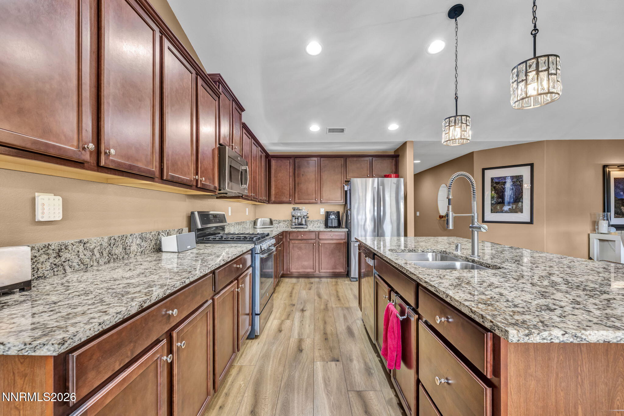 148 Snake Road Dayton, NV 89403 - Photo 14 of 57 a kitchen with kitchen island granite countertop wooden cabinets and granite counter tops