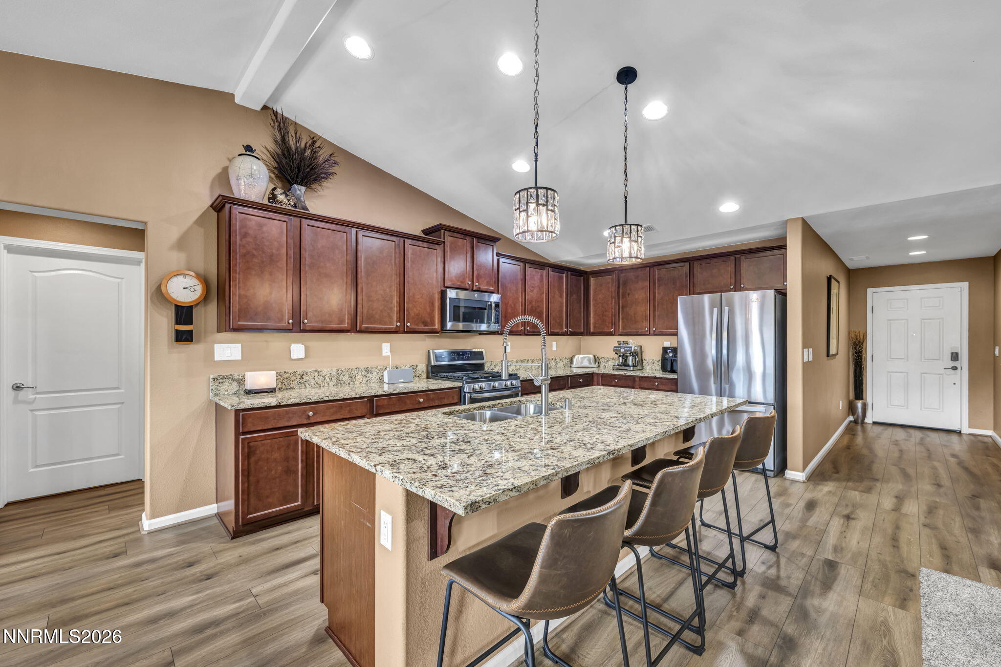 148 Snake Road Dayton, NV 89403 - Photo 17 of 57 a kitchen with stainless steel appliances granite countertop wooden cabinets refrigerator and microwave