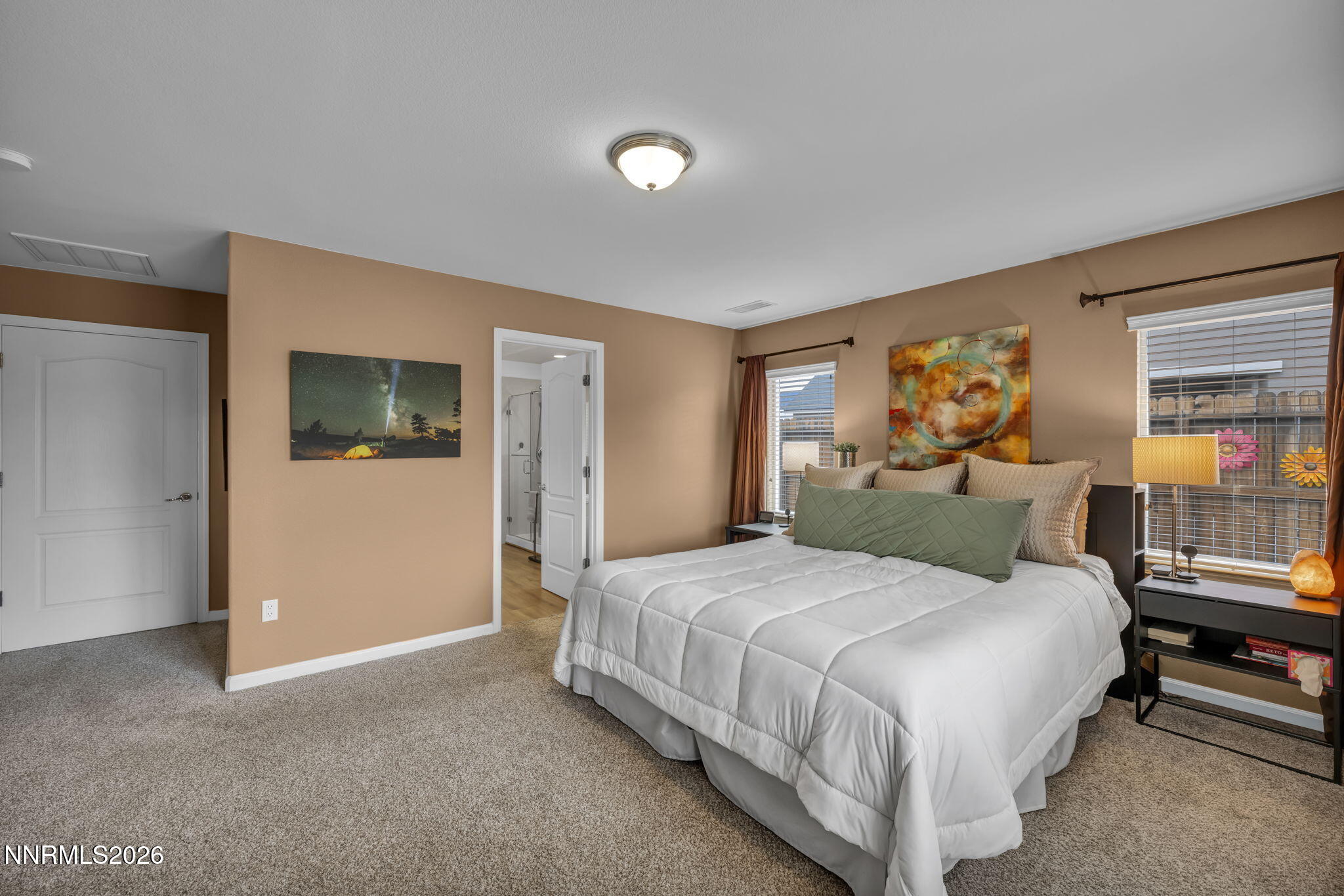 148 Snake Road Dayton, NV 89403 - Photo 20 of 57 a bedroom with a large bed and a flat tv screen on dresser