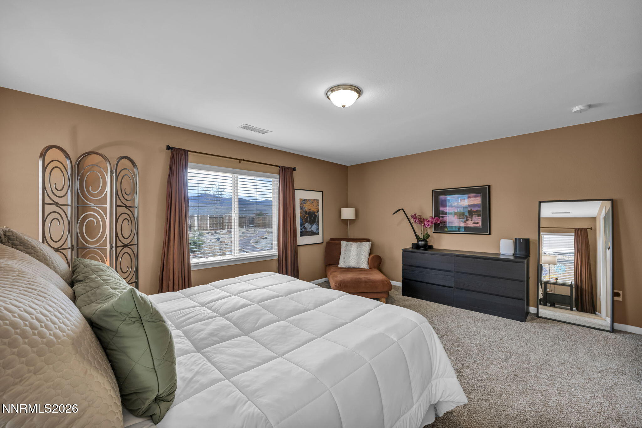 148 Snake Road Dayton, NV 89403 - Photo 22 of 57 a bedroom with a large bed and a dresser