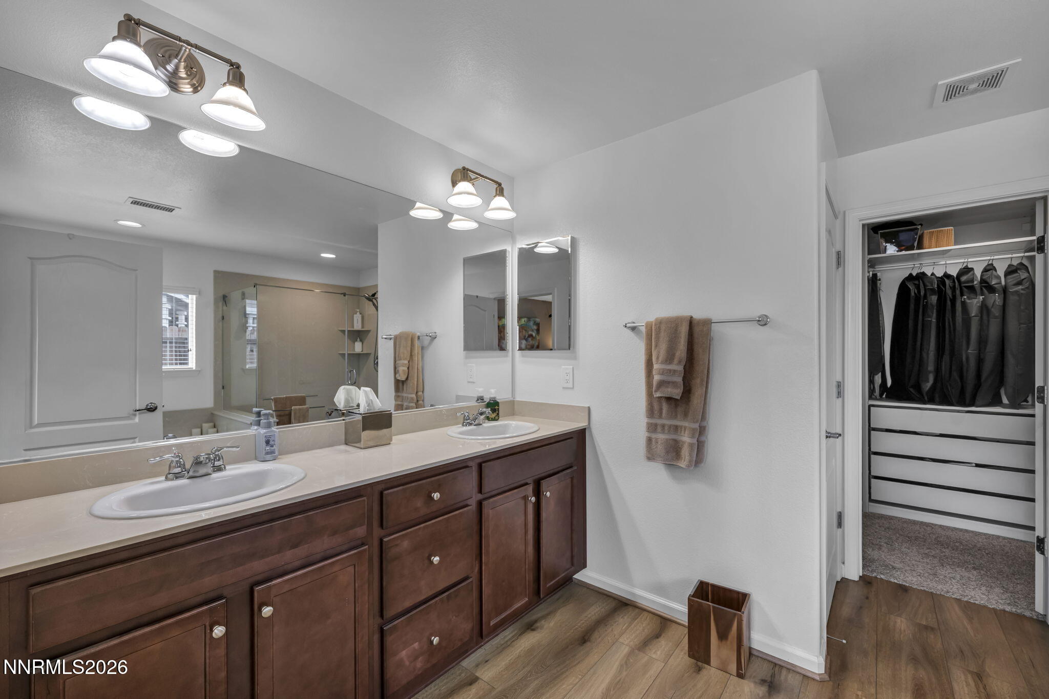 148 Snake Road Dayton, NV 89403 - Photo 24 of 57 a bathroom with a double vanity sink and a mirror