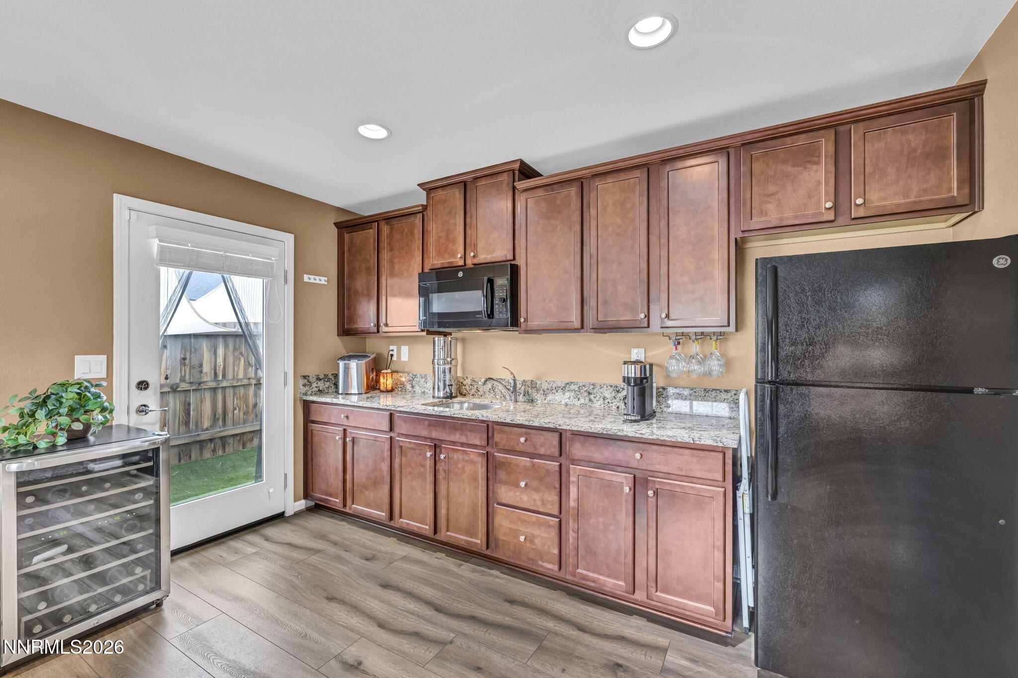 148 Snake Road Dayton, NV 89403 - Photo 31 of 57 a kitchen with stainless steel appliances granite countertop a stove a sink and a refrigerator with wooden cabinets