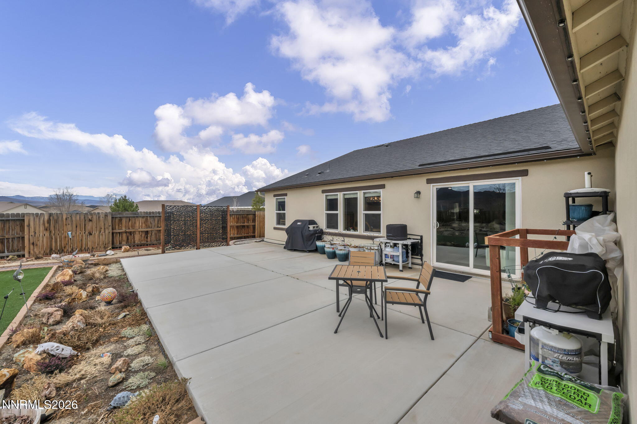 148 Snake Road Dayton, NV 89403 - Photo 46 of 57 a patio with a table and chairs and potted plants