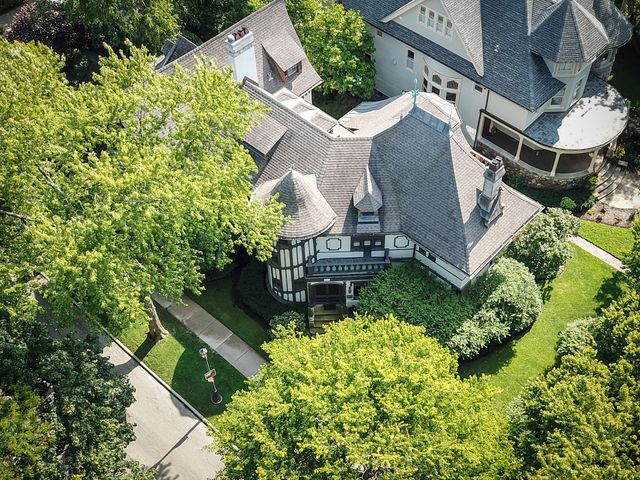 an aerial view of a house with garden space and street view