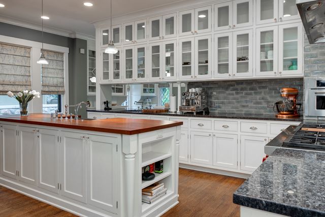 a kitchen with stainless steel appliances granite countertop a sink and a stove