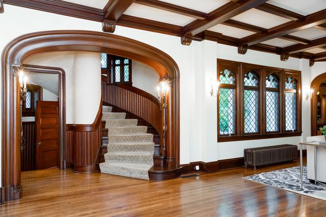 a view of staircase with wooden floor and a rug