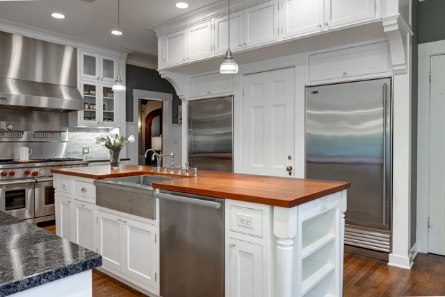 a kitchen with stainless steel appliances granite countertop a sink and a stove
