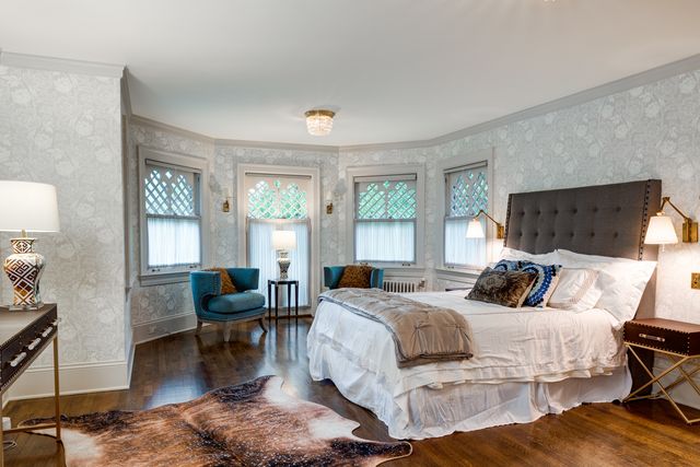 a bedroom with a bed a couch and dresser in it