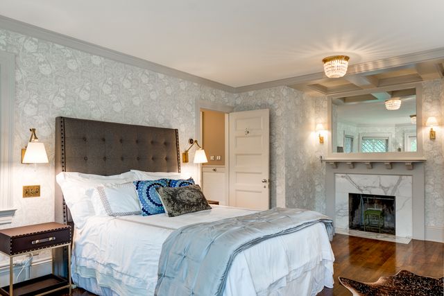 a bedroom with bed and a fireplace