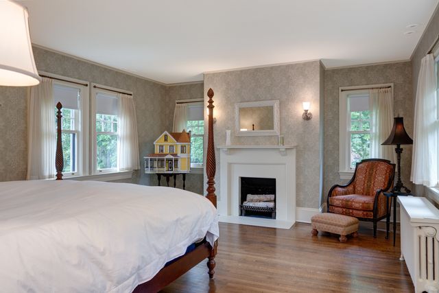 a bedroom with furniture and a fireplace