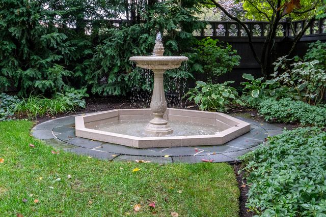 a view of a fountain in the garden with a fountain