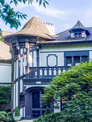 a front view of a house with plants and entryway