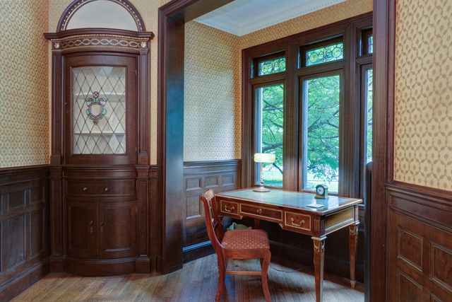 a room with a table chairs and a window