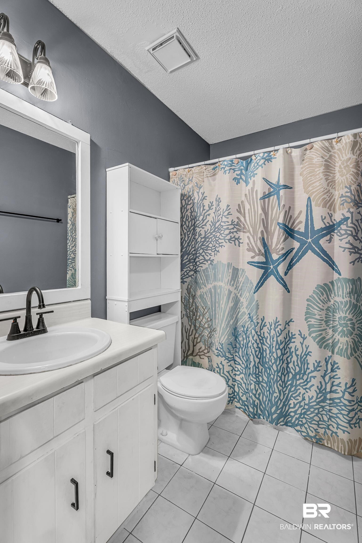 6135 Oak Cliff Drive Eight Mile, AL 36613 - Photo 26 of 30 Full bath with vanity, a textured ceiling, light tile patterned floors, and a shower with shower curtain