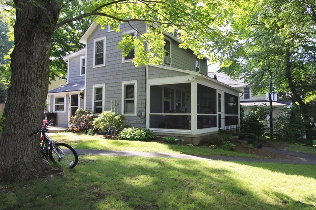 a view of a house with yard and sitting area