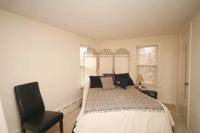 a bedroom with a bed and chair