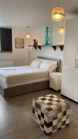 a spacious bedroom with a bed and ceiling fan