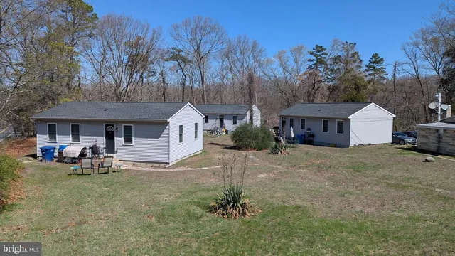 a view of a house with a yard and sitting area
